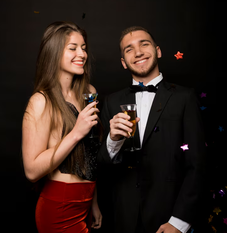 imgi_20_smiling-man-woman-dinner-jacket-evening-wear-with-glasses-drinks-near-confetti_23-2147989310